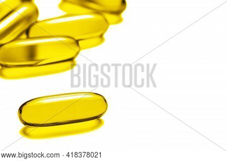 Yellow Capsules Isolated On White. Medicine Healthcare Background. Drugs Dose Tablet. Painkiller Pil