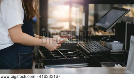 Cropped Shot Of Young Asian Woman Working In Small Business And Recive Money From Customers