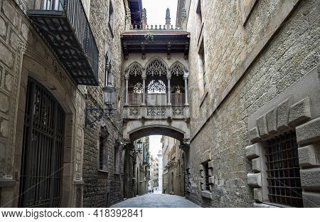Spain, Barcelona, March, 2021: Pont Del Bisbe And Narrow Street Near Gothic Cathedral Of The Holy Cr