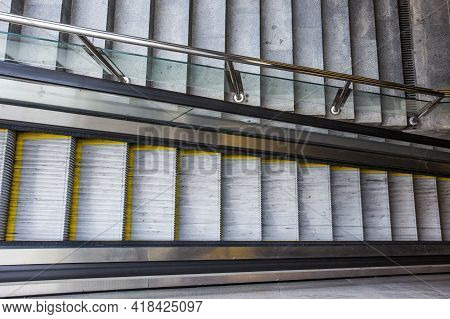 Empty Escalator And Stairs Separated By Glass Railings In Underpass. Modern Transportation, Urban In