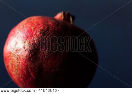 Fruit Of Pomegranate In Dim Blue Light . Red Exotic Fruit