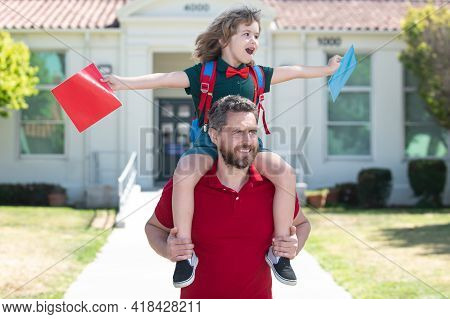 Outdoor School. School Boy Going To School With Father. Dad And Son Having Fun Near School Yard. Con