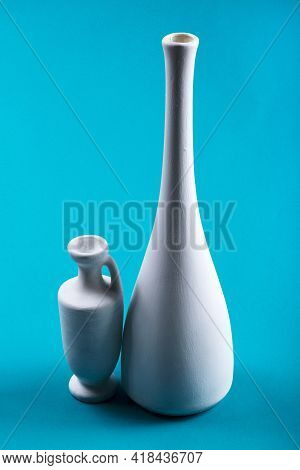 Still Life With White Vases On Blue Background