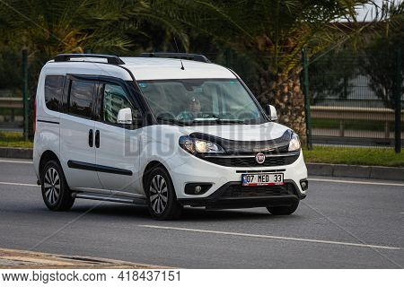 Alanya, Turkey  - April 13  2021:   White  Fiat Duplo Is Driving Fast On The Street On A Warm Summer