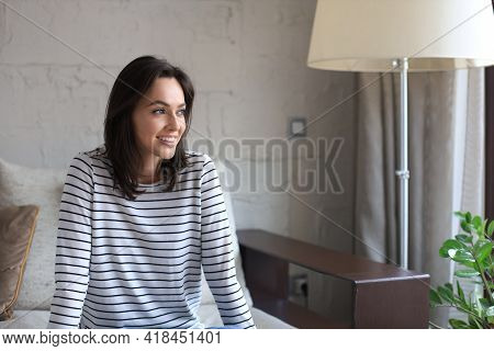 Beautiful Young Woman Sitting On Sofa, Indoors.