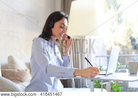 Freelance Operator Talking With Headsets And Consulting Clients From Home Office.