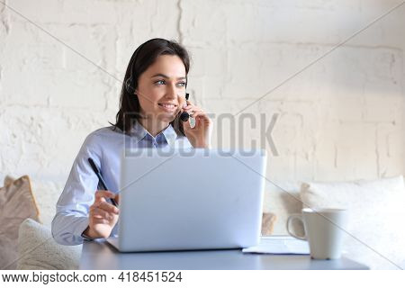 Freelance Operator Talking With Headsets And Consulting Clients From Home Office.
