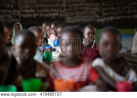 Mzuzu, Malawi. 30-05-2018. Group Of Black Children Having Snack Inside Their Classroom During A Scho