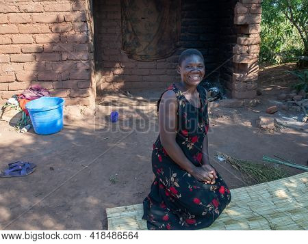 Mzuzu, Malawi. 30-05-2018. Happy Afro-descendent Mother Smiling At The Camera In Front Of Her House 