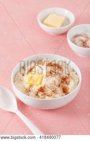 rice pudding with butter cinnamon. french riz au lait, norwegian risgrot, traditional breakfast dessert