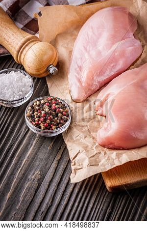 Raw Chicken Fillet On A Dark Wooden Rustic Background