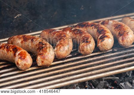 Delicious Grilled Sousages. Barbiquing Sousages On Hot Grill.