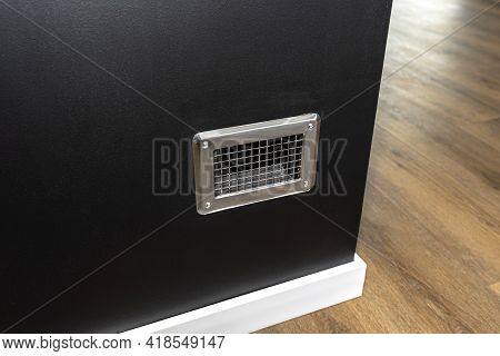 Condensate Tank Behind The Grille In A Modern Fireplace With A Closed Combustion Chamber Standing In