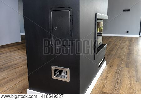 Inspection Door And Condensate Tank Behind The Grille In A Modern Fireplace With A Closed Combustion