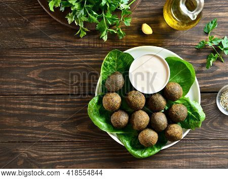 Falafel Balls. Deep Fried Balls From Ground Chickpeas. Traditional Middle Eastern Food. Wooden Backg