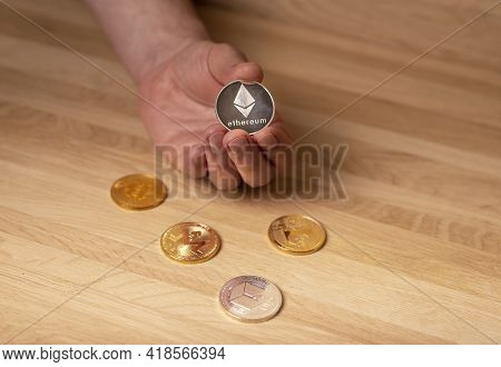 Silver Etherium Coin In Male Hand. Cryptocurrency Concept.