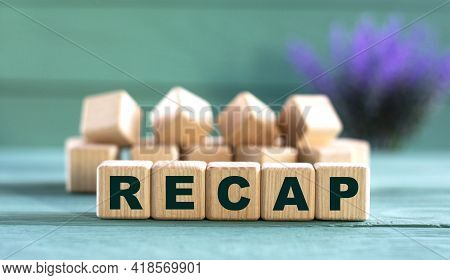 Recap - Word On Wooden Cubes On A Green Background With Lavender. Business Concept