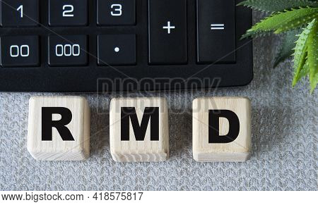 Rmd (required Minimum Distribution) - Acronym On Wooden Cubes On A Gray Background With A Calculator