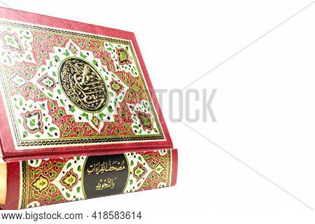 A Picture Of Holy Quran On Isolated White Background. Large Writen Arabic Word Mentioned Holy Quran 
