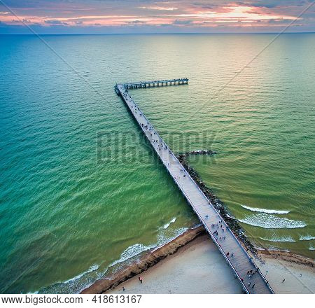 Palanga Resort Public Bridge And Baltic Sea Coast With Sunset Background. Lithuania Tourist Landmark
