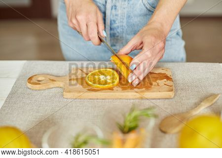 Female Hand Cut Orange, Woman Preparing, Making Citrus And Rosemary Fresh Lemonade