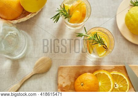 Citrus And Rosemary Fresh Lemonade In Glass On A White Table At Home