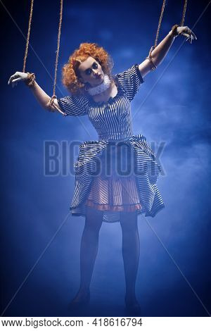 Puppet theater and circus. The actress plays a doll on strings at a performance in a puppet theater. Full length portrait in vintage style.