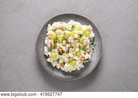 Curd Rice With Cashews, Grapes, Cilantro On A Grey Background.