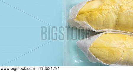 Fresh Durian Fruit In Packaging For Delivery. Banner Durian Packaging With Copy Space On Blue Pastel