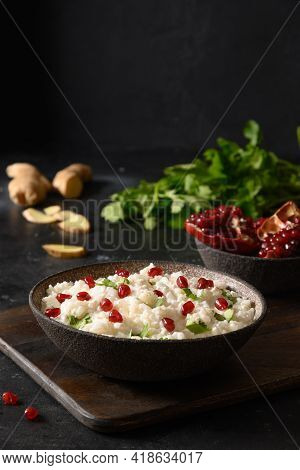 Curd Rice With Pomegranate, Cilantro, Mustard Seeds, Ginger On A Black Background. Indian Cuisine