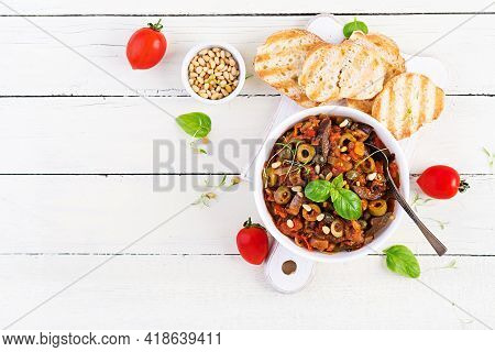 Traditional Italian Caponata And Toast On A Wooden White Table. Sicilian Caponata. Top View, Above, 
