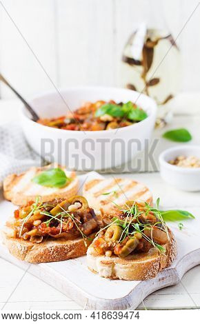 Traditional Italian Caponata And Toast On A Wooden White Table. Sicilian Caponata.