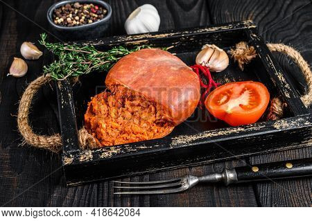 Mallorcan Sobrassada Cured Pork Meat Sausage In A Wooden Tray. Black Wooden Background. Top View