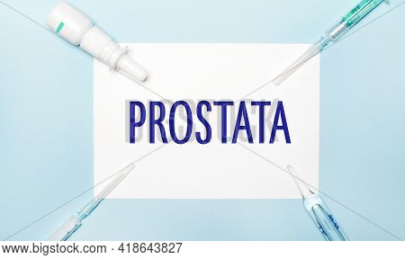 On A Light Blue Background, Syringes, A Medicine Bottle, An Ampoule And A White Sheet Of Paper With 