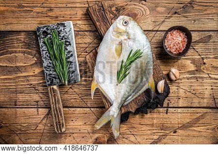 Raw Fish Sunfish Or Pompano On A Wooden Board. Wooden Background. Top View