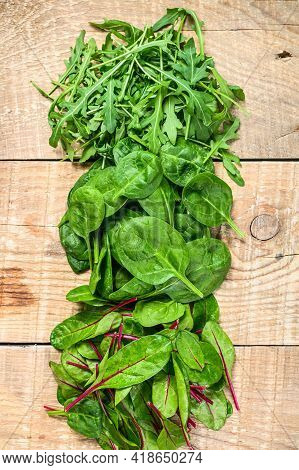 Mix Salad Leafs, Arugula, Spinach And Swiis Chard. Wooden Background. Top View