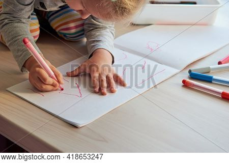 3 Years Girl Draws A Picture. Child At Home, Kindergarden And Preschool Closed During Covid-19