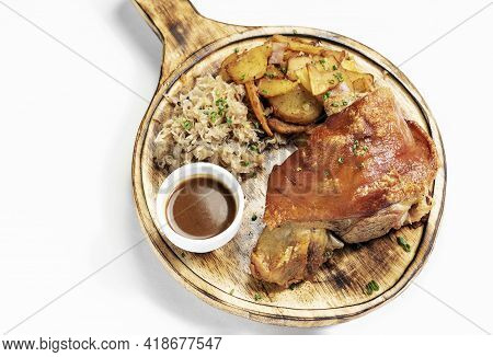 Schweinshaxe Traditional German Pork Knuckle With Sauerkraut And Potatoes Meal On White Background