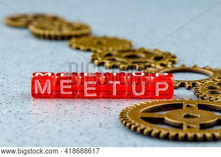 Meetup Written On Red Cubes Background Blurred Gears For The Mechanism. Teamwork Concept