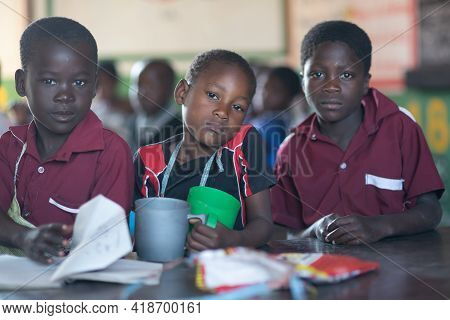 Mzuzu, Malawi. 30-05-2018. Portrait Of Afro-descendent Children Having A Snack During A Break At The