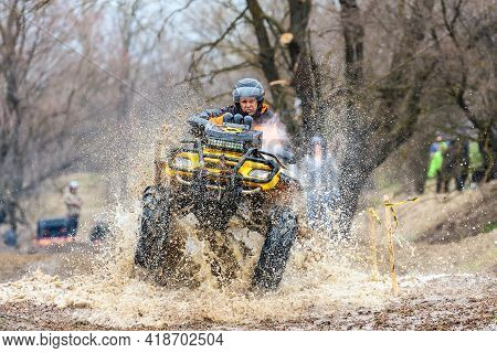 Afipsip, Russia - October 31, 2020: Sportsman On Quad Bike Drives Splashing In Water At Mud Racing C
