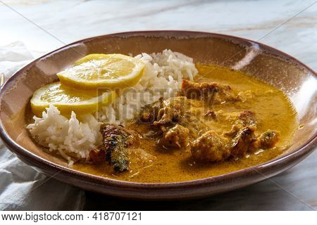 African Chicken Curry Also Known As Kuku Paka, Served With Rice And Sliced Lemon