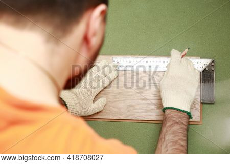 Installation Laminate Or Parquet In The Room, Worker Installing Wooden Laminate Flooring, Marking Th