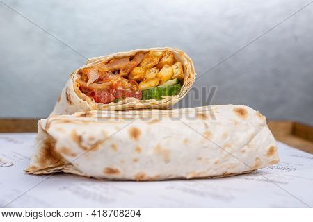 Doner In Pita Bread With Chicken And Vegetables In A Cut.