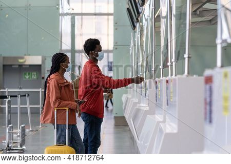 Couple Of Travelers In Protective Mask At Checkin Counter In Airport Before Flight In Coronavirus Ep