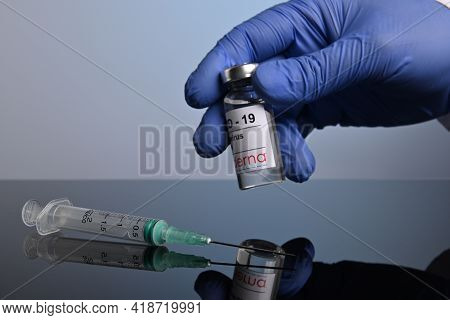 Krasnoyarsk, Russia. April 27, 2021. Gloved Hand Takes Moderna Covid-19 Vaccine. Vaccination Syringe