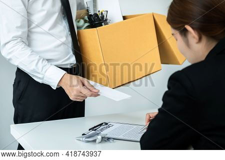 Business Man Employee Holding Brown Cardboard Box And Sending A Letter Of Resignation To The Executi