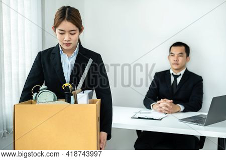 Business Woman Employee In Suit Is Stressed And Carrying Personal Belongings In Brown Cardboard Box 