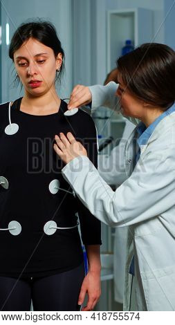Scientist Researcher Preparing Woman Patient For Endurance Test