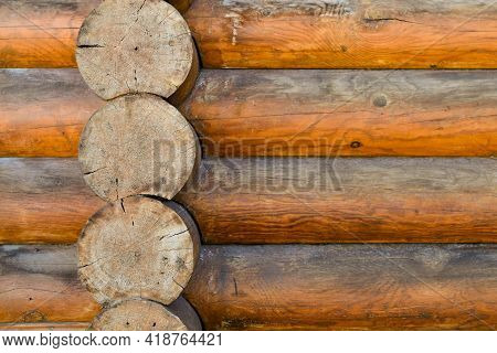 Texture Of Wall Of House Made Of Rounded Logs. Facade Of Log House, Space For Text. Wooden Log Wall 